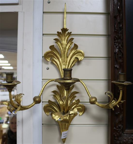 A pair of gilt metal three light wall sconces